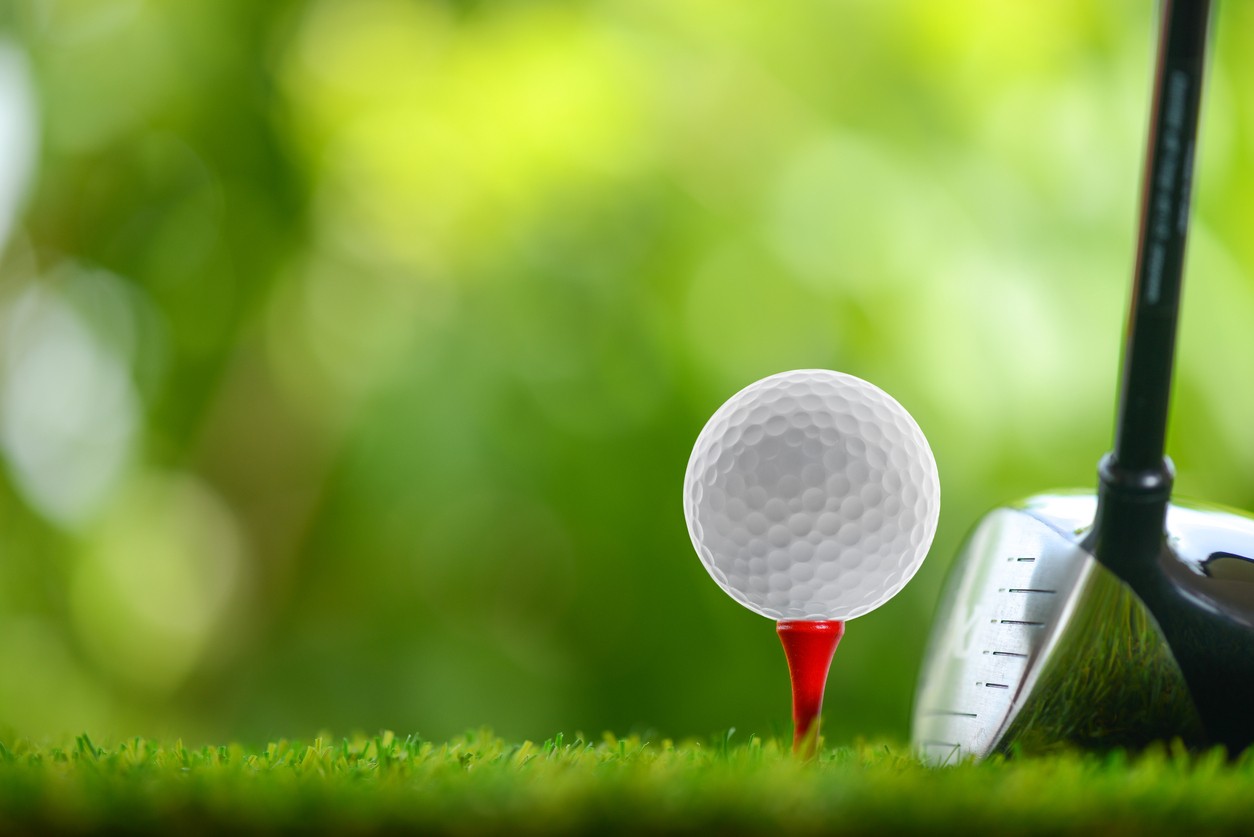 golf-ball-and-club-on-green