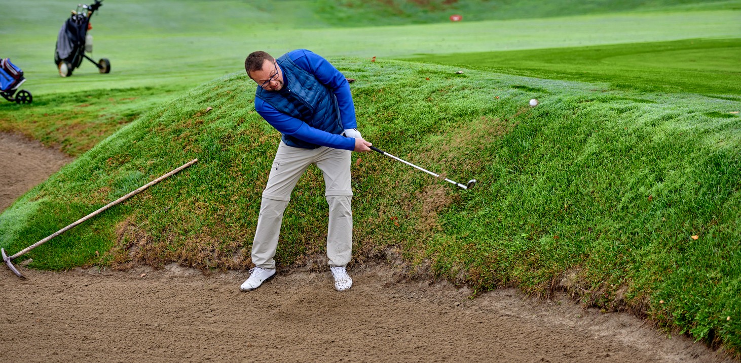 golfer-chipping-from-sand-bunker