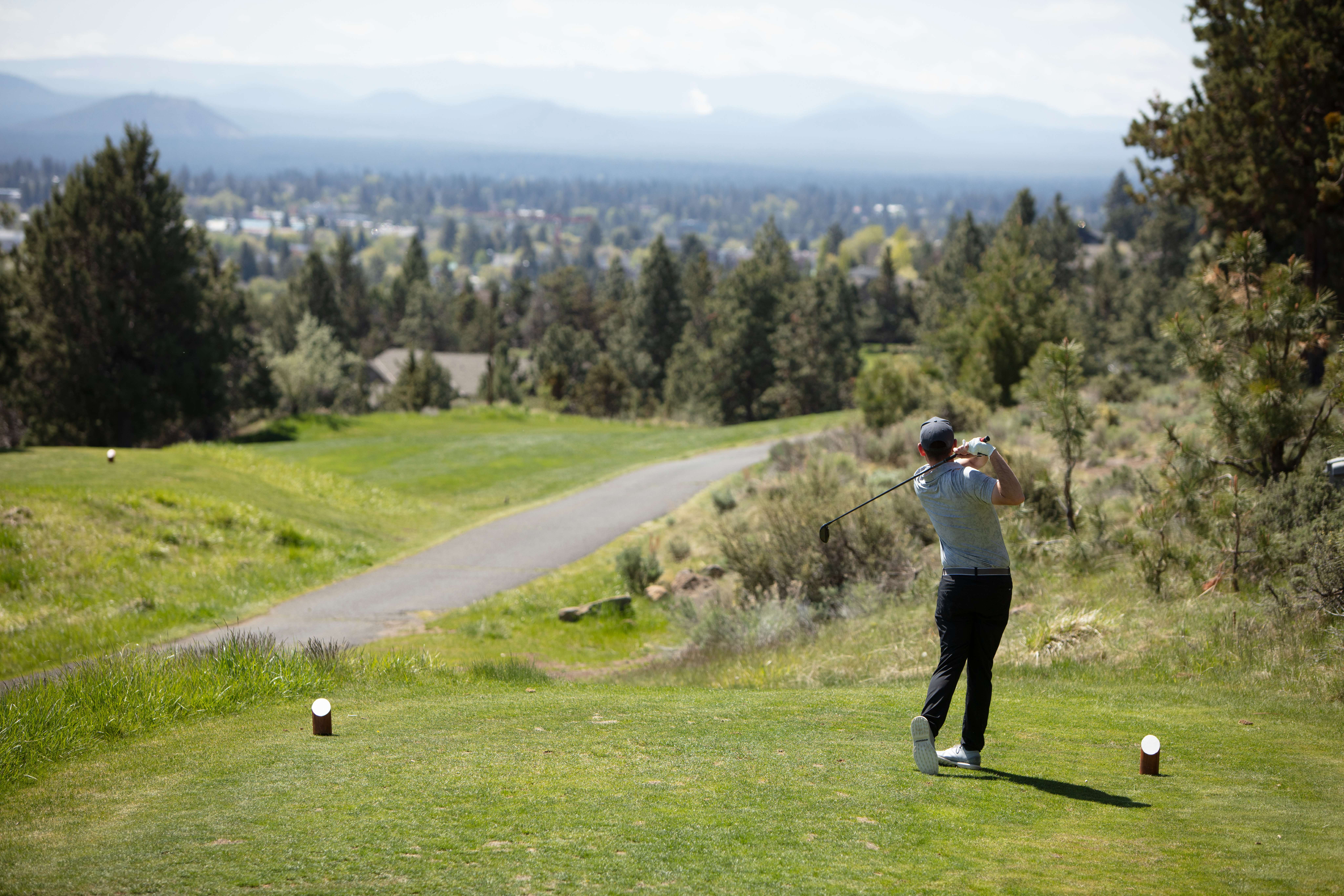 golfer swinging onto open course 