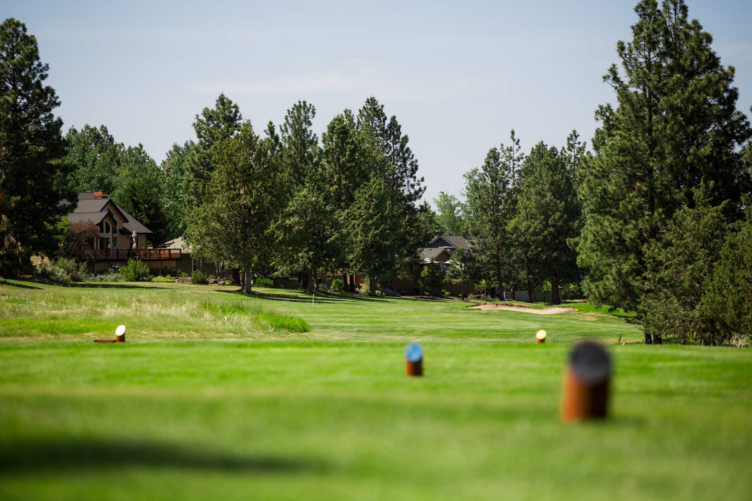 Golf course in Bend, Oregon showing tees and a green scenic background.