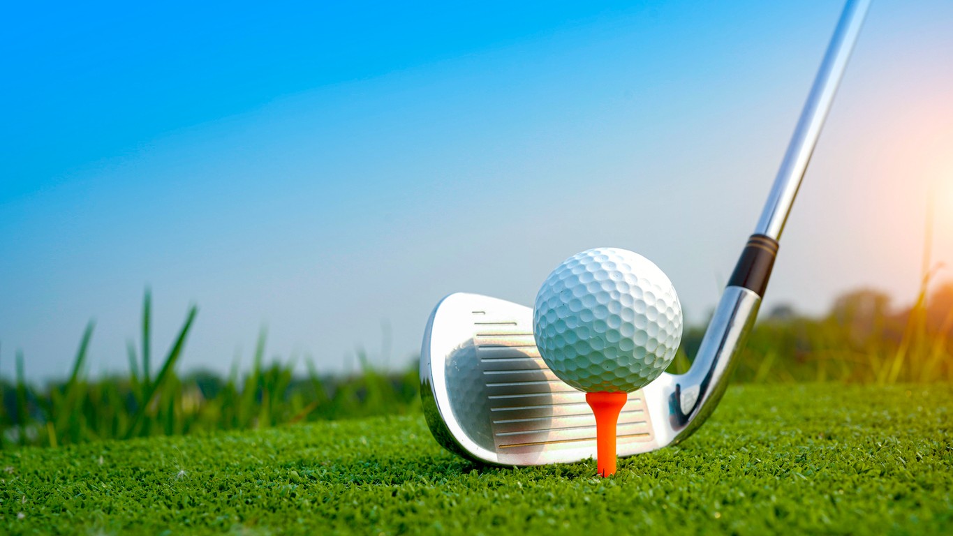Golf ball being putt at a golf course. 