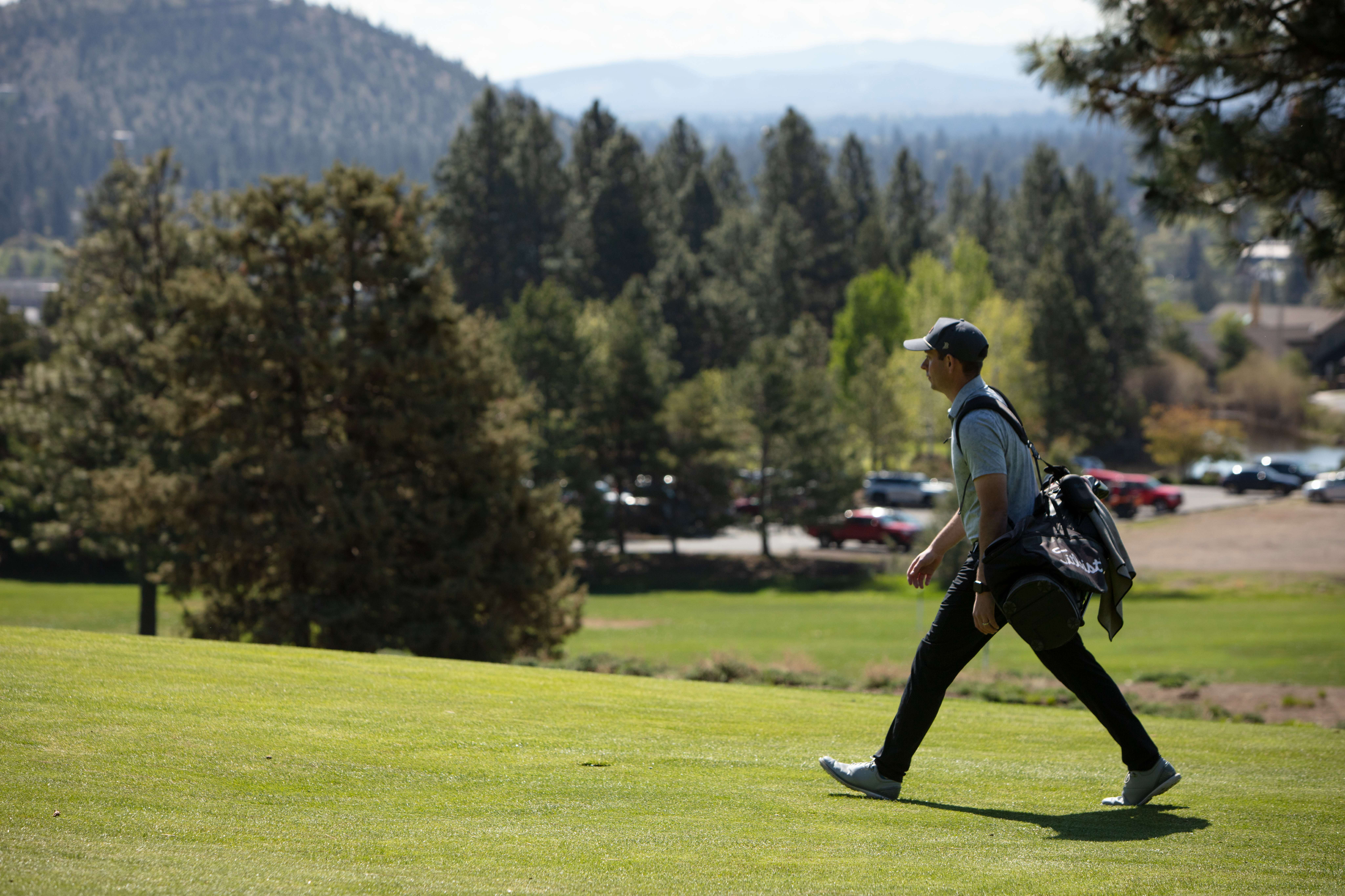 Golfer walking at River's Edge. 